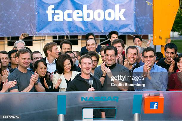 Mark Zuckerberg, chief executive officer of Facebook Inc., center, speaks during the remote opening bell ringing cerermony for the opening of trading...