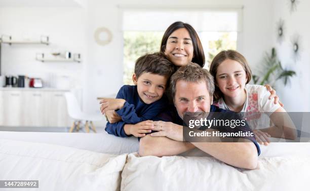 portrait of a happy family of four smiling at home - family with two children stock pictures, royalty-free photos & images