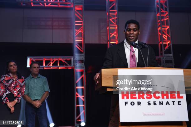 Georgia Republican Senate candidate Herschel Walker delivers his concession speech as his wife Julie Blanchard and former football player Doug Flutie...