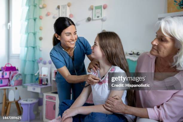 doctor on a house call doing a medical exam on a girl - kids call 911 stock pictures, royalty-free photos & images