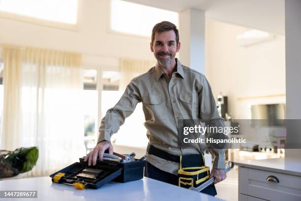 portrait of a plumber or electrician working at a house with his tools - handyman stockfoto's en -beelden