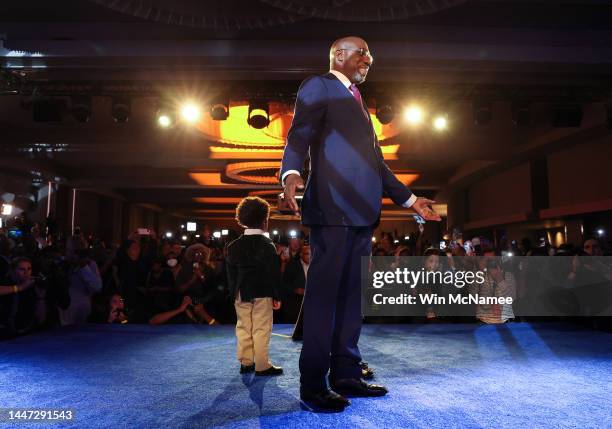 Georgia Democratic Senate candidate U.S. Sen. Raphael Warnock speaks alongside his son Caleb Warnock, during an election night watch party at the...