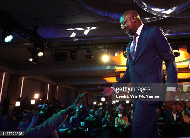 Georgia Democratic Senate candidate U.S. Sen. Raphael Warnock greets supporters during an election night watch party at the Marriott Marquis on...