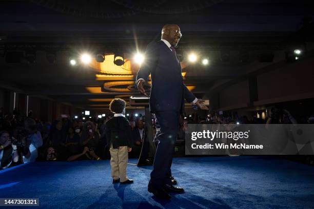 Georgia Democratic Senate candidate U.S. Sen. Raphael Warnock waves to supporters after speaking at an election night watch party at the Marriott...