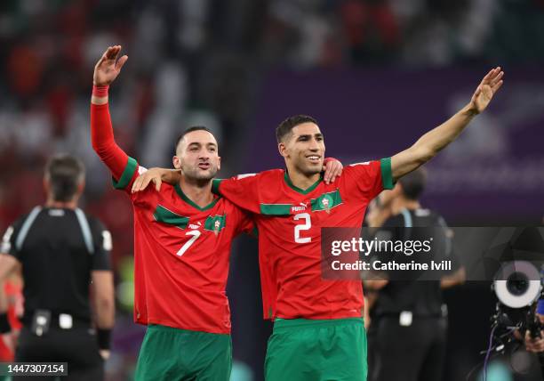 Hakim Ziyech of Morocco and Achraf Hakimi of Morocco celebrate victory following the FIFA World Cup Qatar 2022 Round of 16 match between Morocco and...