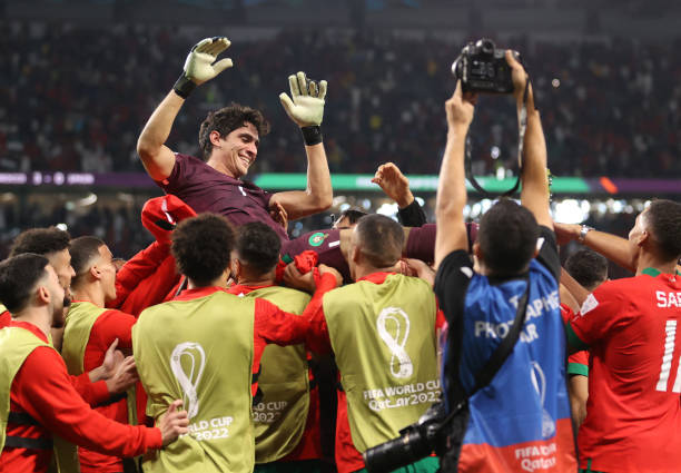 Yassine Bounou of Morocco is thrown into the air following the FIFA World Cup Qatar 2022 Round of 16 match between Morocco and Spain at Education...