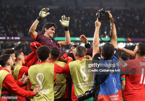 Yassine Bounou of Morocco is thrown into the air following the FIFA World Cup Qatar 2022 Round of 16 match between Morocco and Spain at Education...