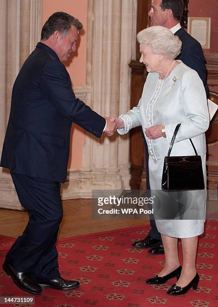 King Abdullah II is greeted by Queen Elizabeth II at a lunch For Sovereign Monarchs in honour of Queen Elizabeth II's Diamond Jubilee, at Windsor...