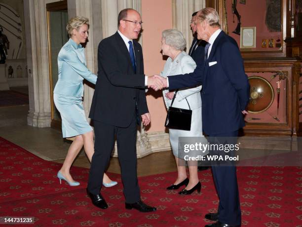 Queen Elizabeth II and Prince Philip, Duke of Edinburgh greet Princess Charlene of Monaco and Prince Albert II of Monaco as they arrive at a lunch...