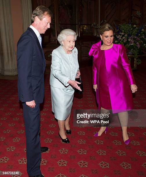 Queen Elizabeth II greets The Grand Duke Henri of Luxembourg and The Grand Duchess Maria Teresa of Luxembourg as they arrive at a lunch for Sovereign...