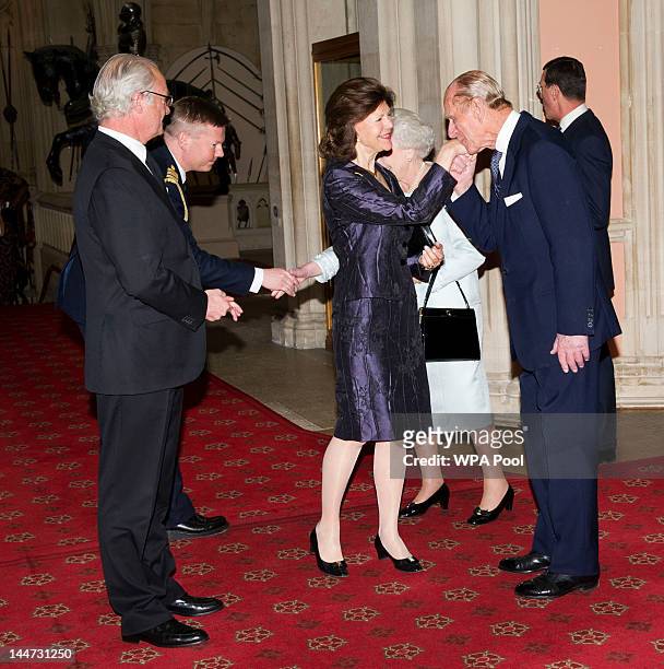 Queen Elizabeth II and Prince Philip, Duke of Edinburgh greet King Carl XVI Gustaf of Sweden and Queen Silvia of Sweden as they arrive at a lunch for...