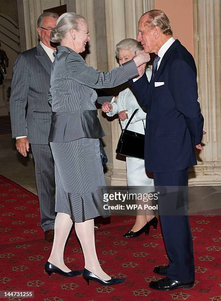 Queen Elizabeth II and Prince Philip, Duke of Edinburgh greet Queen Margrethe of Denmark as she arrives at a lunch for Sovereign Monarch's held in...