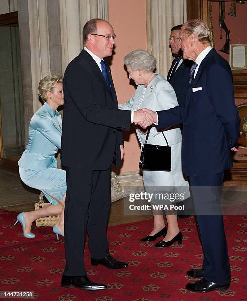 Queen Elizabeth II and Prince Philip, Duke of Edinburgh greet Princess Charlene of Monaco and Prince Albert II of Monaco as they arrive at a lunch...