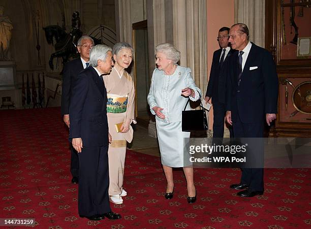 Queen Elizabeth II and Prince Philip, Duke of Edinburgh greet Emperor Akihito of Japan and Empress Michiko as they arrive at a lunch for Sovereign...
