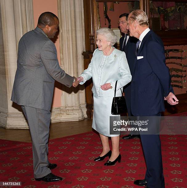 Queen Elizabeth II and Prince Philip, Duke of Edinburgh greet King Mswati III of Swaziland as he arrives at a lunch for Sovereign Monarch's held in...