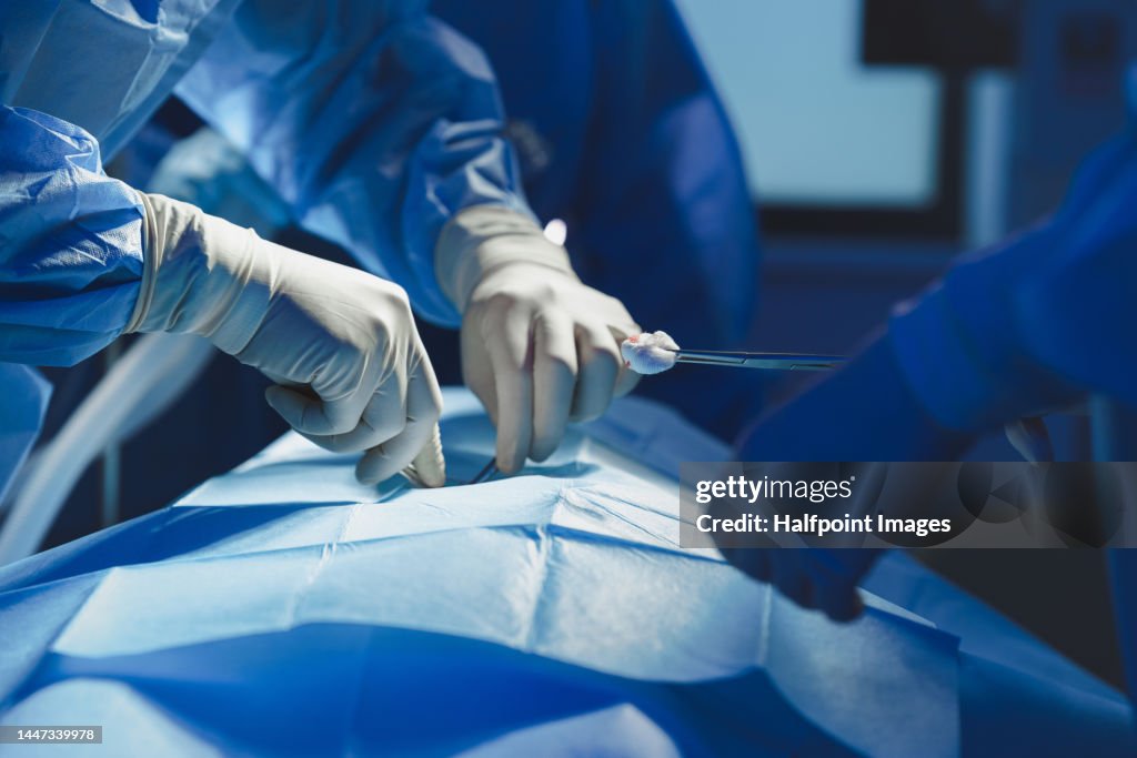 Close-up of surgeon with nurse and and assistant during operation.
