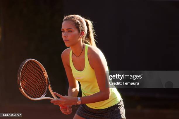 beautiful young woman in tennis ready position - tennis player stock pictures, royalty-free photos & images