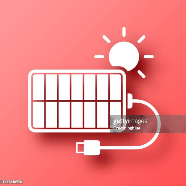 solar charger. icon on red background with shadow - wireless charging stock illustrations