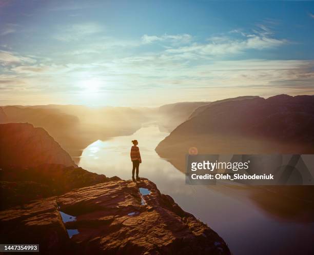 woman hiking in mountains on the background of lysefjorden - explorer bildbanksfoton och bilder