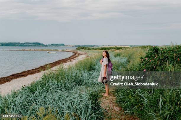 woman walking near the sea in germany - kiel stock pictures, royalty-free photos & images