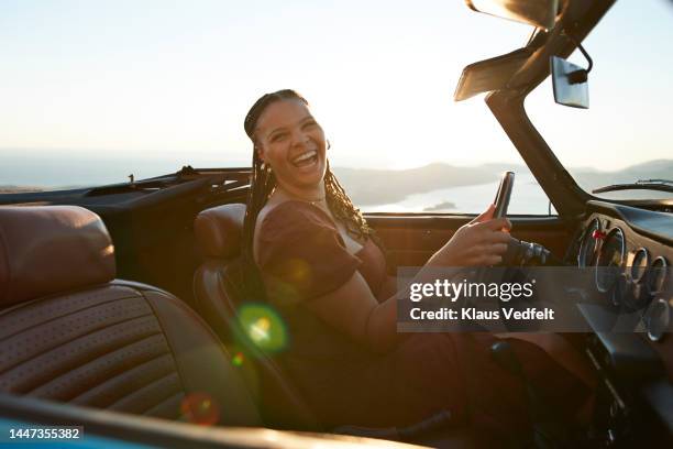 woman having fun while driving car - old car side view stock pictures, royalty-free photos & images