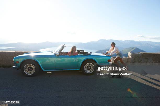 woman pushing convertible car - convertible top stock pictures, royalty-free photos & images