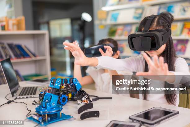 two asian student studying about robotic design with vr glass in the classroom - asian-students-classroom-computer stock pictures, royalty-free photos & images