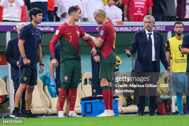 Pepe gives Cristiano Ronaldo the captain´s armband watched by head Coach Fernando Santos during the FIFA World Cup Qatar 2022 Round of 16 match...