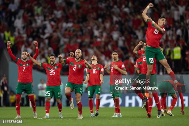 Morocco players celebrate as Morocco goalkeeper Yassine Bounou saves a penalty from Sergio Busquets of Spain during the FIFA World Cup Qatar 2022...