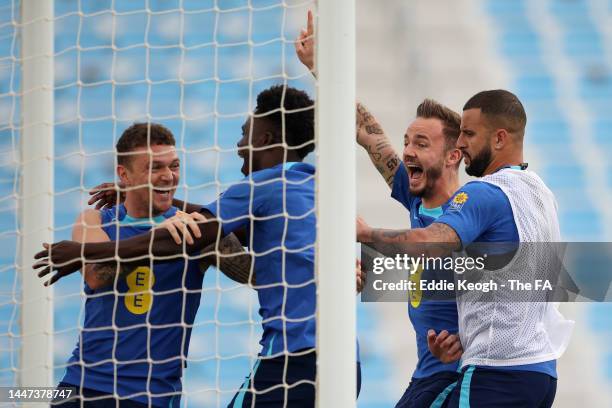 Kieran Trippier, Bukayo Saka, James Maddison and Kyle Walker of England react during an England training session at Al Wakrah Stadium on December 07,...