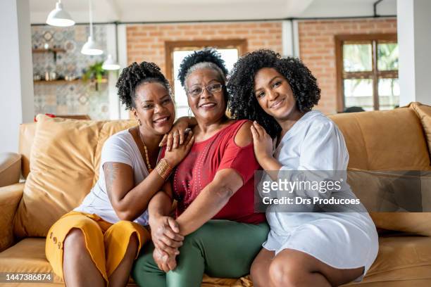 portrait of mother with her daughters at christmas - black granny stock pictures, royalty-free photos & images