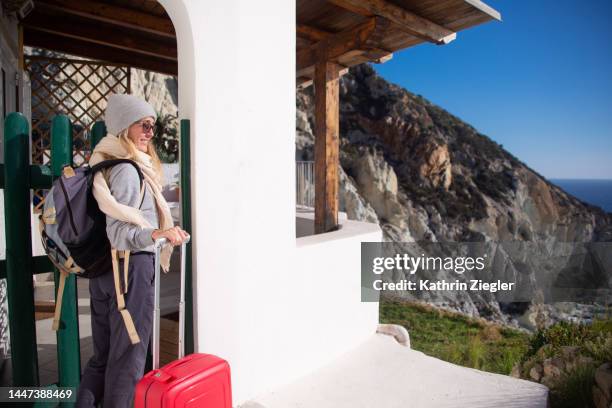 female traveler at the front door with luggage - house rental stock pictures, royalty-free photos & images