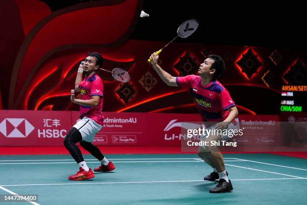 Mohammad Ahsan and Hendra Setiawan of Indonesia compete in the Men's Doubles Round Robin match against Aaron Chia and Soh Wooi Yik of Malaysia during...