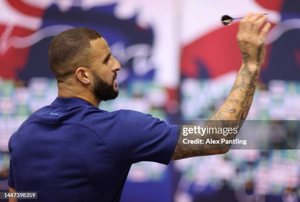 Kyle Walker plays darts against a member of the media prior to an England press conference at Al Wakrah Stadium on December 07, 2022 in Doha, Qatar.