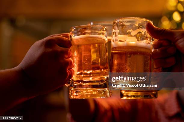 friends clinking beer glasses in pub,happy time. - glas bier stockfoto's en -beelden