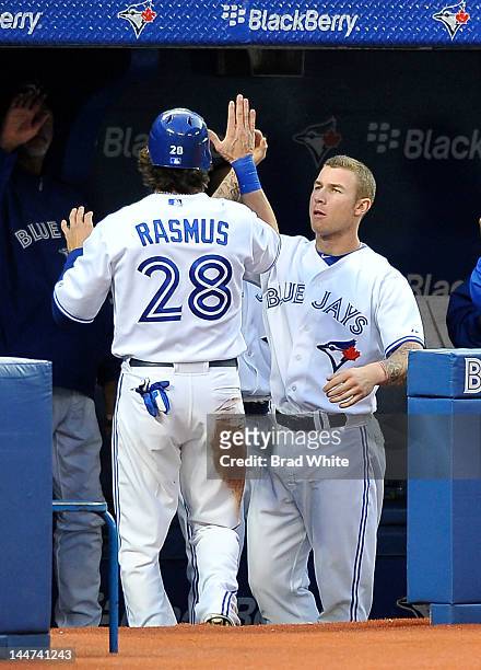 Colby Rasmus and Brett Lawrie of the Toronto Blue Jays celebrate in the dugout during MLB game action against the Tampa Bay Rays May 14, 2012 at...