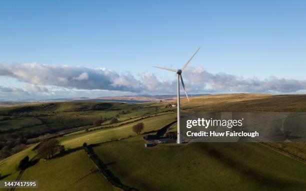 An aerial view of an onshore Wind Turbine located on the mountain to on Markham Common with Snow on the Brecon Beacons in the backgroun on December...