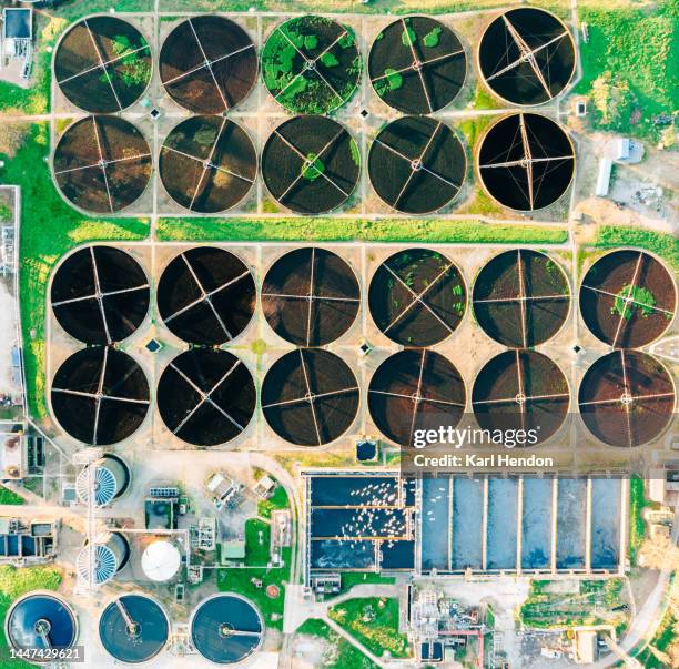 an aerial view of a water treatment plant at sunset - biomass ecological concept stock pictures, royalty-free photos & images