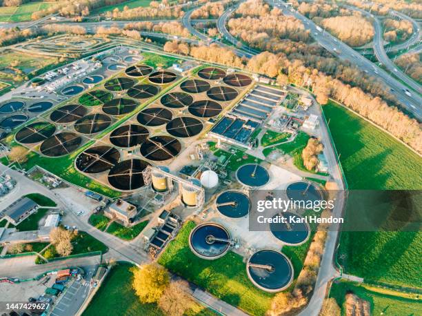 an aerial view of a water treatment plant at sunset - water pollution pipe stock pictures, royalty-free photos & images