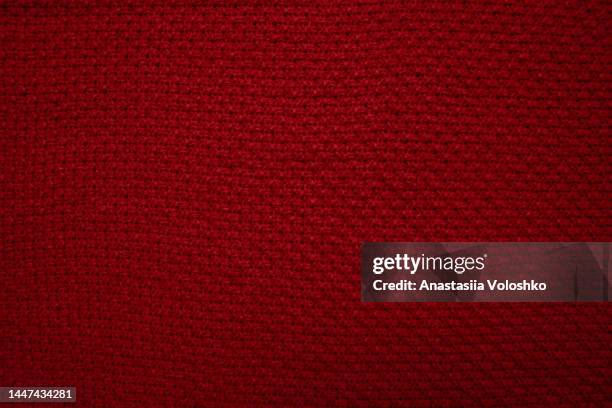 texture of a knitted red christmas sweater. perfect background - red jumper stock pictures, royalty-free photos & images