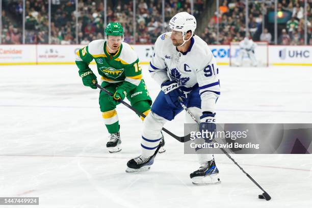 John Tavares of the Toronto Maple Leafs skates with the puck past Mason Shaw of the Minnesota Wild in the first period of the game at Xcel Energy...