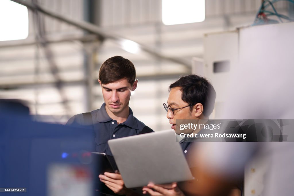 IT support technicians inspecting machine