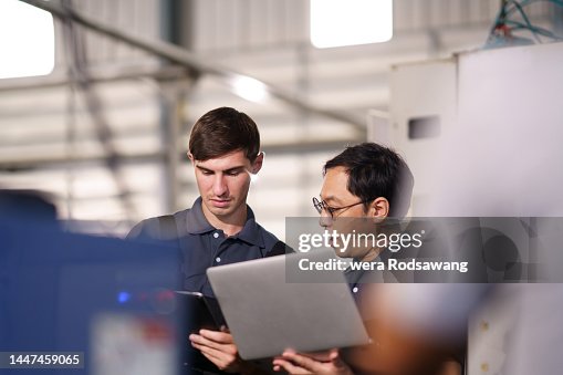 IT support technicians inspecting machine IT support technicians inspecting machine