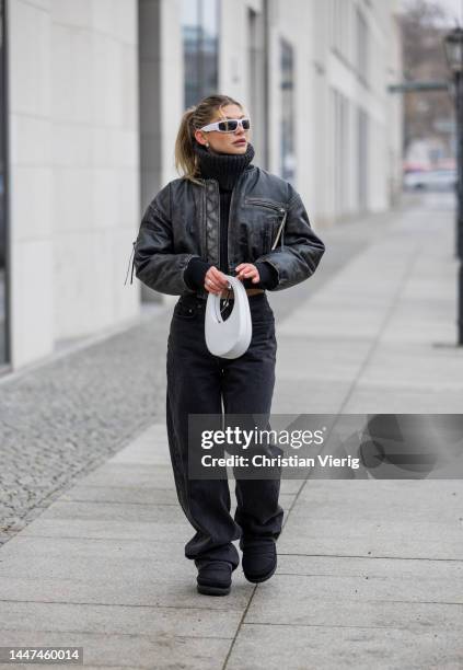 Sophia Geiss wears jeans LeGer by Lena Gercke, black cropped turtleneck knit Zara, Acne bomber jacket, white Coperni bag, Ugg boots on December 06,...
