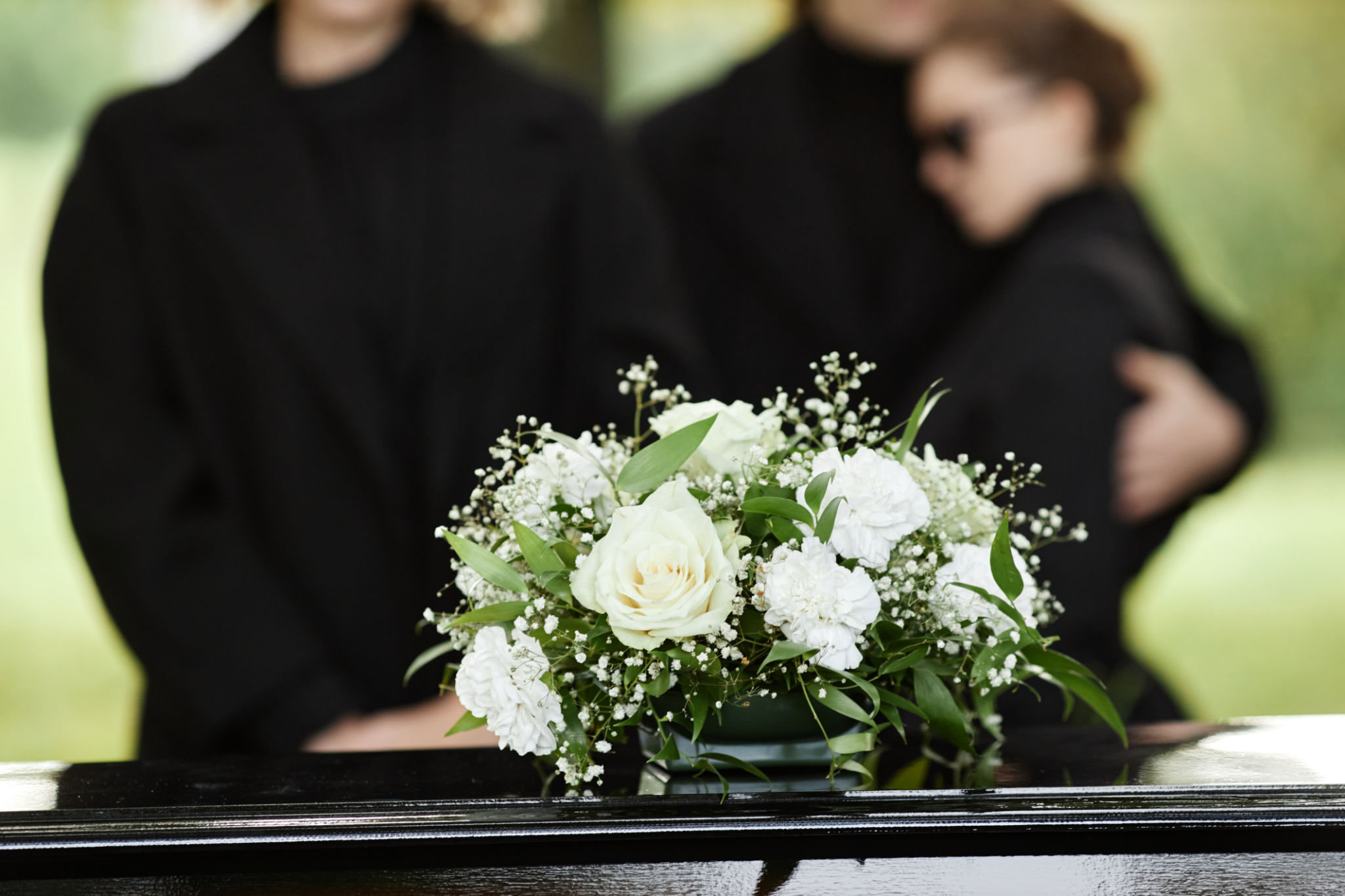 Close up of flower bouquet on coffin Close up of flower bouquet on coffin