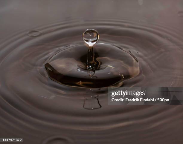 close-up of drop splashing in water,sweden - vätska stock pictures, royalty-free photos & images