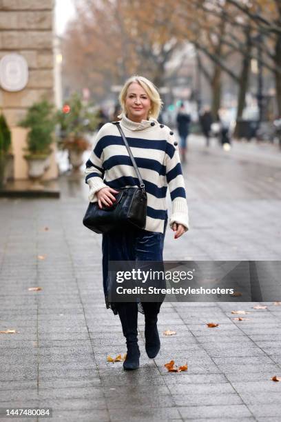 German TV presenter Ulla Kock am Brink wearing a dark blue and beige knitted striped pullover by Zadig & Voltaire, a dark blue midi asymmetrical...