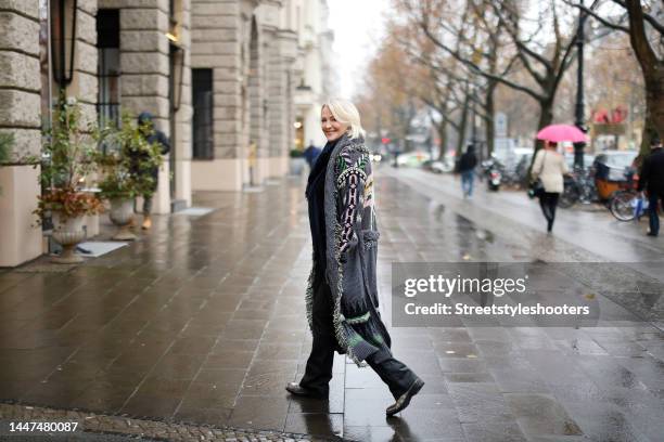 German TV presenter Ulla Kock am Brink wearing a long multicolored coat with fringe detail by Zadig & Voltaire, a dark blue scarf by Zadig &...