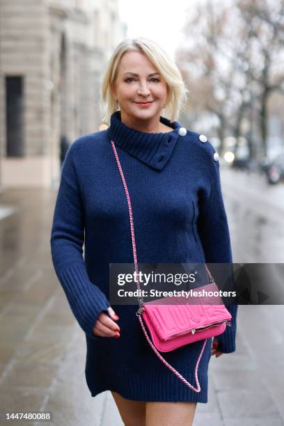 German TV presenter Ulla Kock am Brink wearing a dark blue knitted mini sweater dress with button details by Zadig & Voltaire and a pink bag by Zadig...