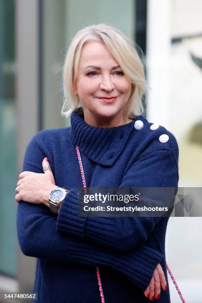 German TV presenter Ulla Kock am Brink wearing a dark blue knitted mini sweater dress with button details by Zadig & Voltaire during a street style...
